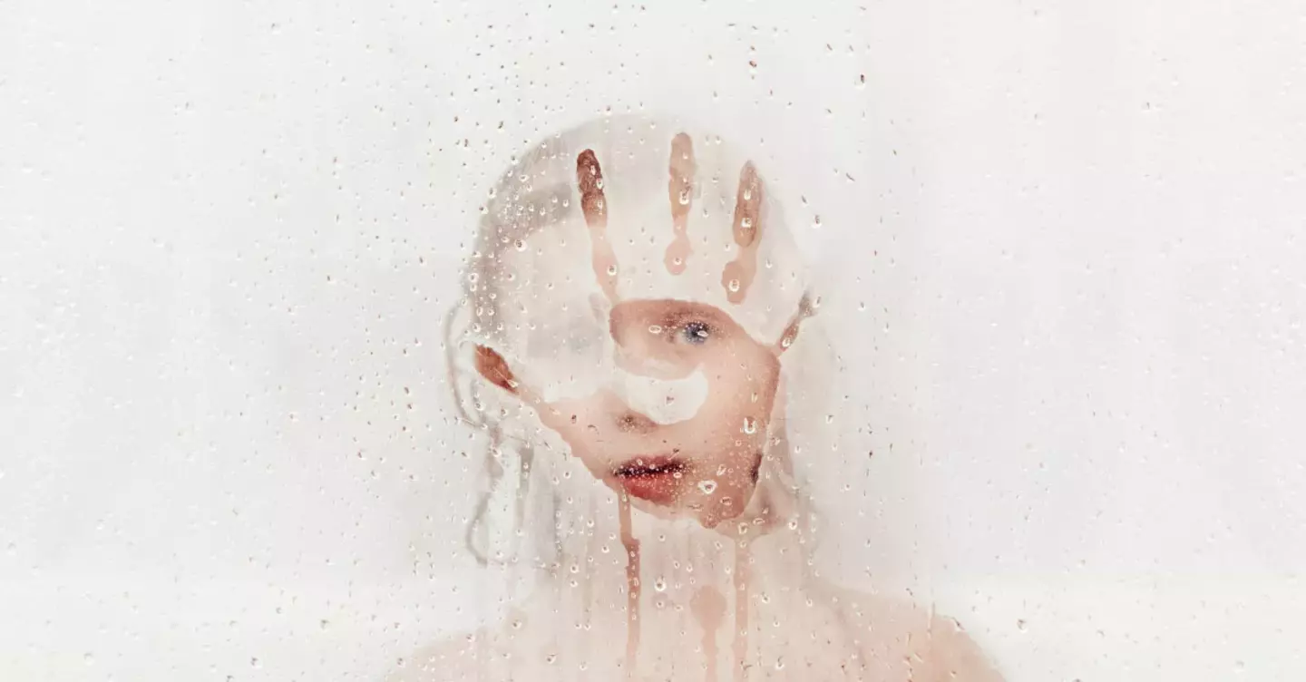 A kid enjoying the hot water shower in winter