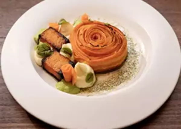 Gourmet meal featuring salmon fillet and vegetables elegantly plated.