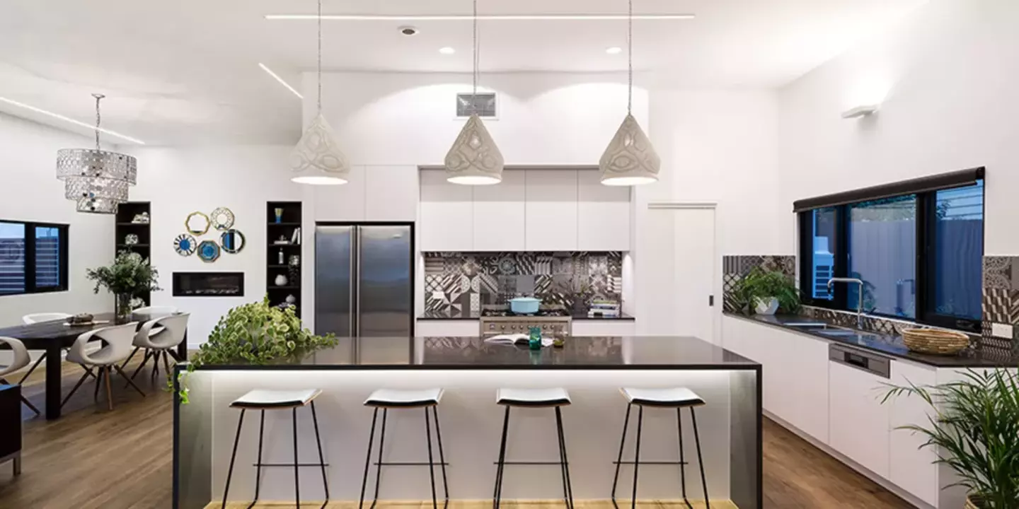 Modern kitchen with island, stools and hanging lights