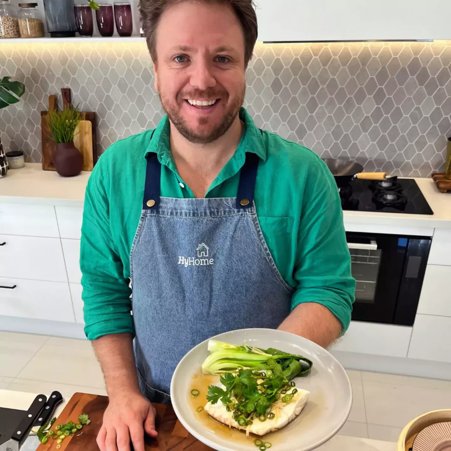 Chef Michael Weldon preparing a fresh meal using a gas-powered stove in a home kitchen.