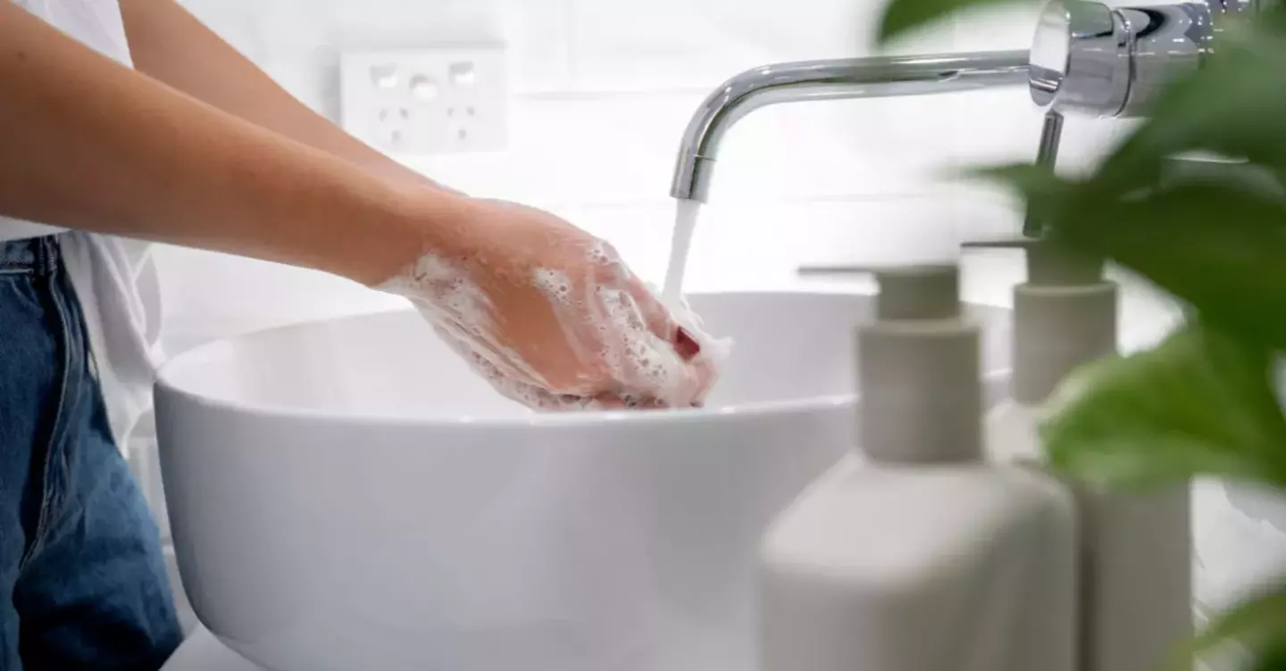 washing hands  with soap under running water