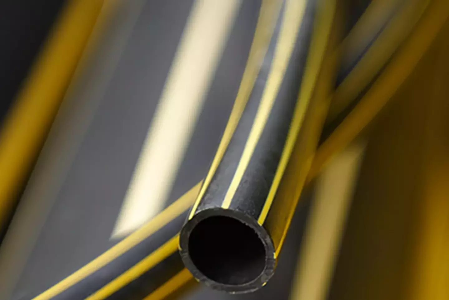 Close-up of coiled yellow gas pipes used in residential and commercial installations.